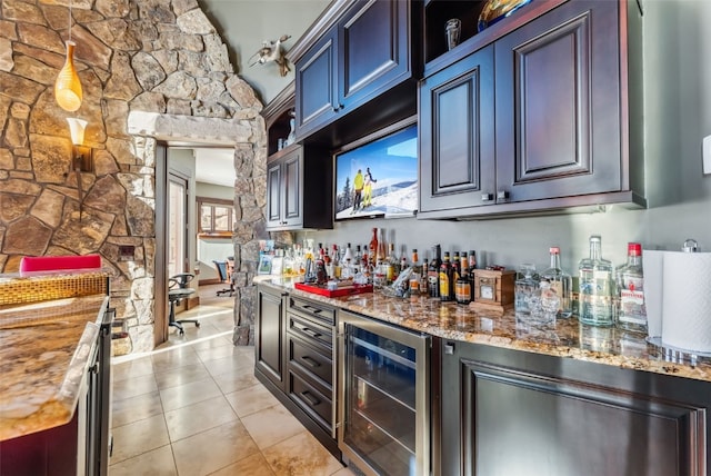 bar with a dry bar, wine cooler, and light tile patterned floors