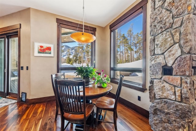 dining space with wood finished floors and baseboards