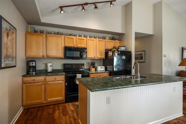 kitchen with dark wood-style floors, a sink, high vaulted ceiling, an island with sink, and black appliances