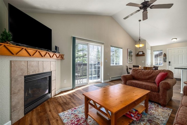 living room featuring wood finished floors, baseboard heating, a fireplace, high vaulted ceiling, and ceiling fan