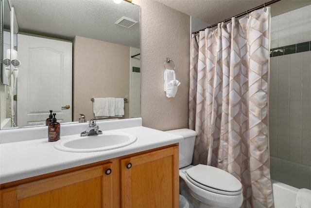 bathroom with a textured wall, a textured ceiling, and toilet