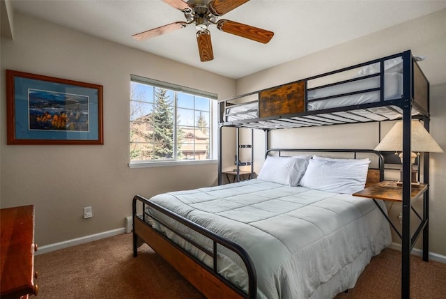 carpeted bedroom featuring baseboards and a ceiling fan