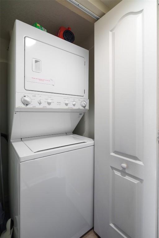 laundry room featuring stacked washer and dryer and laundry area