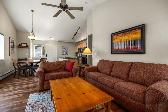 living room featuring track lighting, a ceiling fan, vaulted ceiling, and dark wood-style flooring