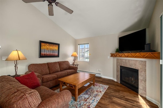 3303 Covey Cir Unit 804, Steamboat Springs, CO 80487 - living area with vaulted ceiling, wood finished floors, a tiled fireplace, baseboard heating, and ceiling fan