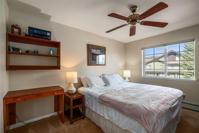 bedroom with baseboard heating, ceiling fan, and carpet flooring