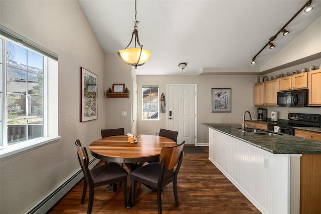 dining room featuring dark wood-style flooring, baseboards, lofted ceiling, baseboard heating, and track lighting