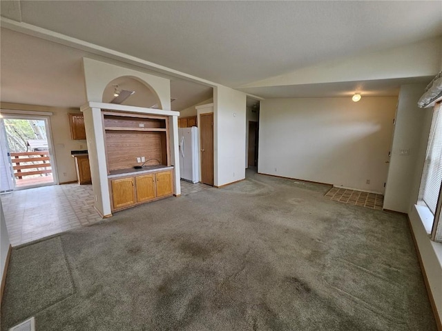631 Arrowhead Dr, Como, CO 80456 - unfurnished living room with vaulted ceiling, baseboards, and light colored carpet