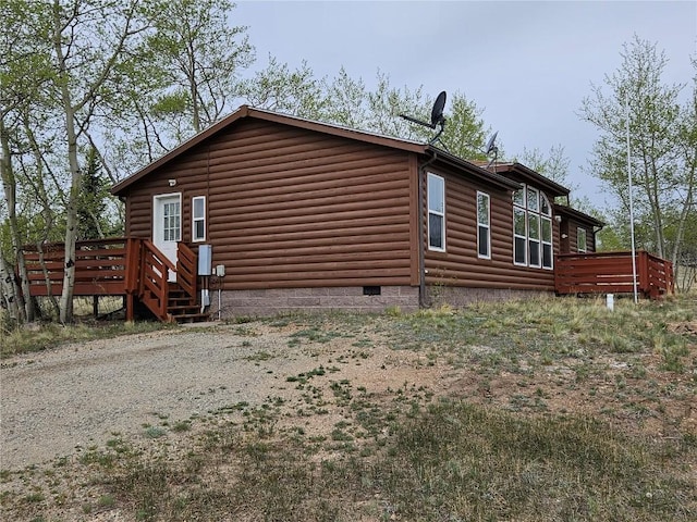 631 Arrowhead Dr, Como, CO 80456 - view of property exterior with crawl space, a deck, and faux log siding