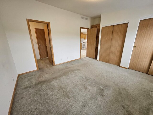 631 Arrowhead Dr, Como, CO 80456 - unfurnished bedroom featuring light carpet, two closets, and baseboards