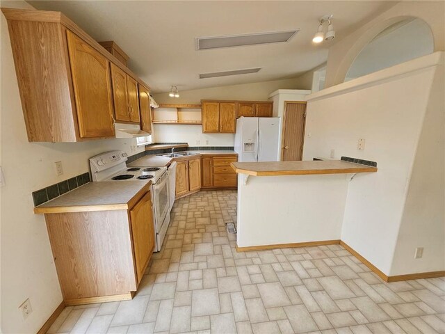 631 Arrowhead Dr, Como, CO 80456 - kitchen featuring white appliances, under cabinet range hood, lofted ceiling, a sink, and a peninsula