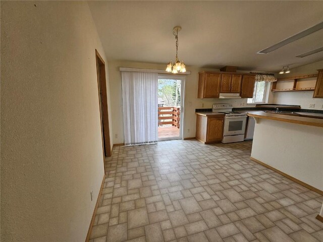 631 Arrowhead Dr, Como, CO 80456 - kitchen with electric stove, brick patterned floors, baseboards, and brown cabinetry