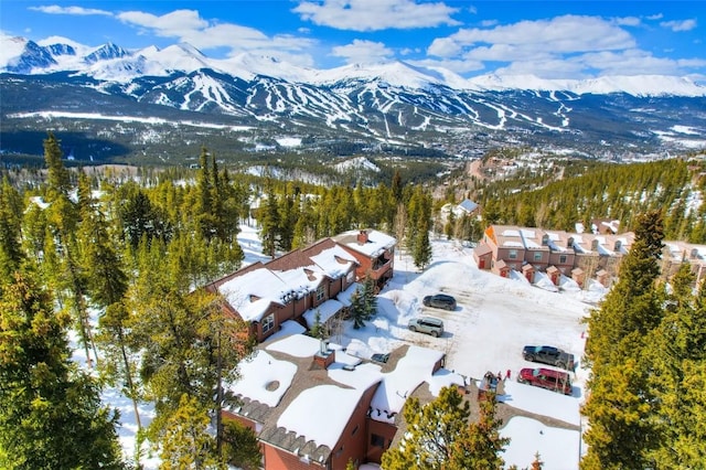 snowy aerial view with a mountain view