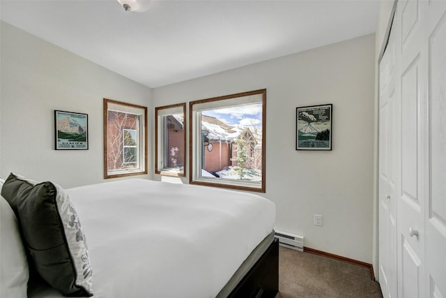 carpeted bedroom with baseboards, a closet, and a baseboard radiator