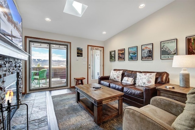living area with recessed lighting, vaulted ceiling with skylight, wood finished floors, and a fireplace