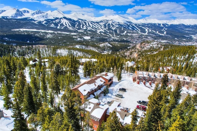 snowy aerial view featuring a mountain view