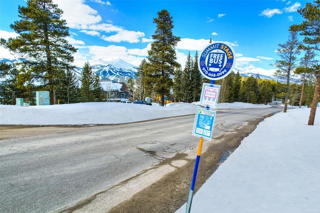 view of road featuring a mountain view and traffic signs