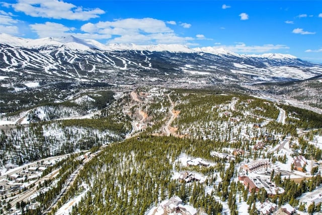 snowy aerial view with a mountain view