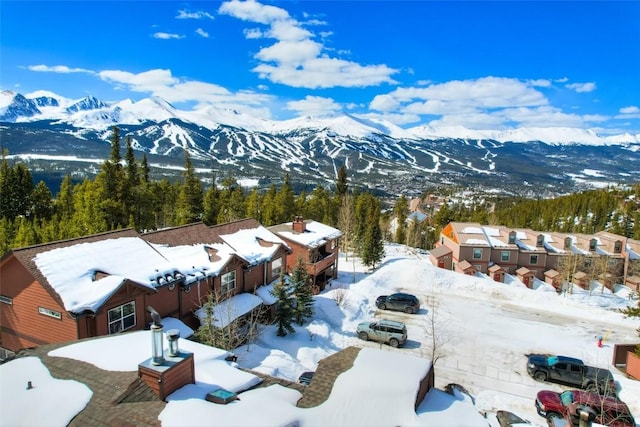 snowy aerial view featuring a mountain view