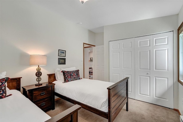 bedroom featuring light colored carpet and a closet