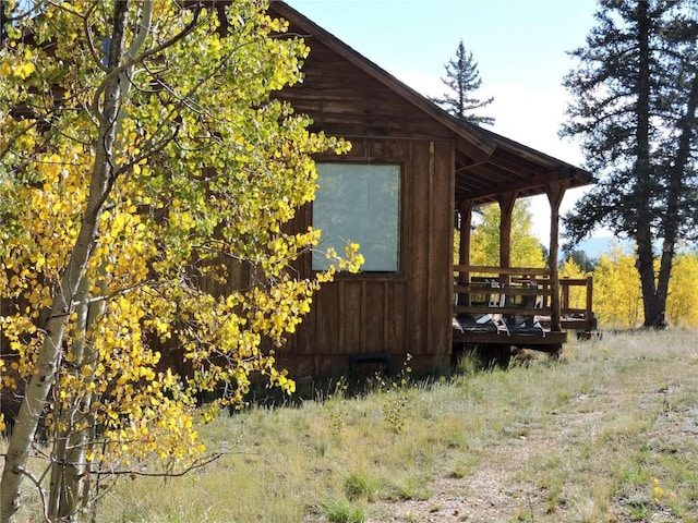 view of property exterior with a wooden deck