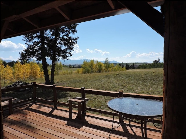 wooden terrace featuring a mountain view and a rural view