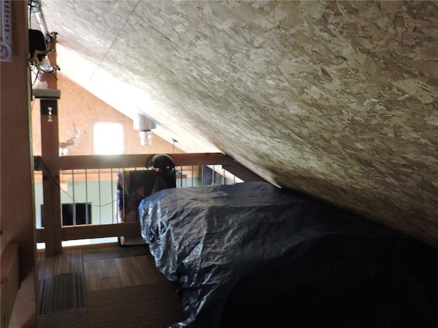 bedroom featuring lofted ceiling and wood finished floors