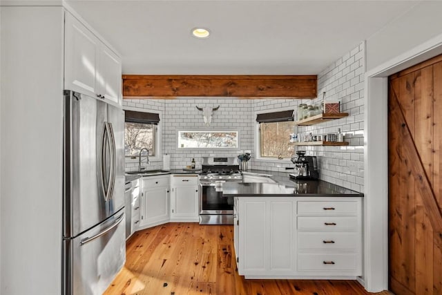 27145 Whitewood Dr E, Steamboat Springs, CO 80487 - kitchen with stainless steel appliances, a sink, dark countertops, tasteful backsplash, and recessed lighting