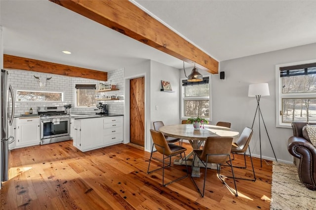 27145 Whitewood Dr E, Steamboat Springs, CO 80487 - dining area with beamed ceiling, light wood-style floors, baseboards, and recessed lighting