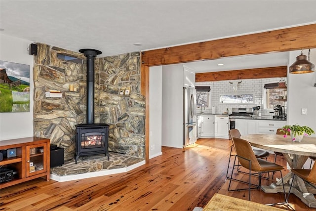 27145 Whitewood Dr E, Steamboat Springs, CO 80487 - dining room with a wood stove and light wood finished floors
