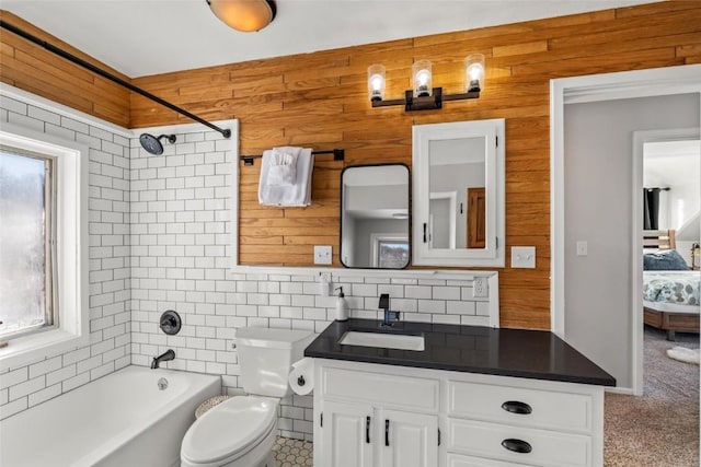 27145 Whitewood Dr E, Steamboat Springs, CO 80487 - ensuite bathroom featuring bathtub / shower combination, toilet, vanity, decorative backsplash, and wooden walls