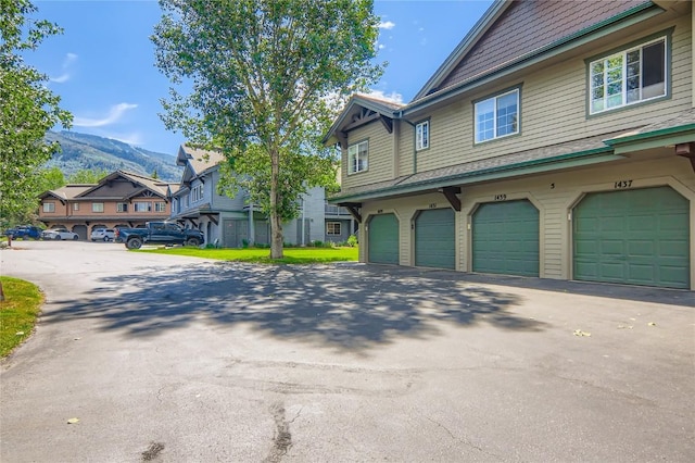 1437 Morgan Ct Unit 1437, Steamboat Springs, CO 80487 - view of property exterior with a mountain view, driveway, and an attached garage