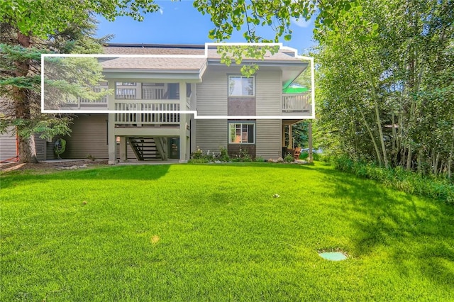 1437 Morgan Ct Unit 1437, Steamboat Springs, CO 80487 - rear view of property with stairway, a yard, roof with shingles, and a balcony