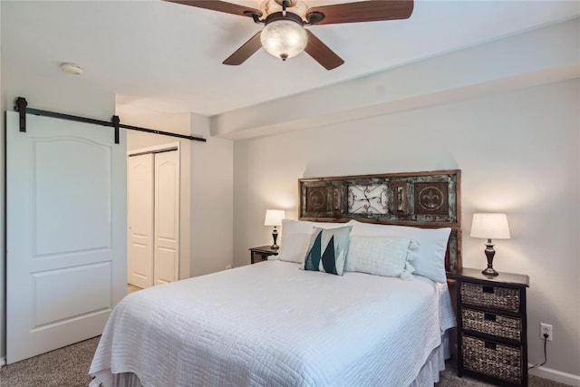 1437 Morgan Ct Unit 1437, Steamboat Springs, CO 80487 - bedroom with carpet floors, a barn door, a closet, and a ceiling fan