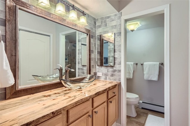 1437 Morgan Ct Unit 1437, Steamboat Springs, CO 80487 - full bath featuring a baseboard radiator, vanity, and tile patterned flooring
