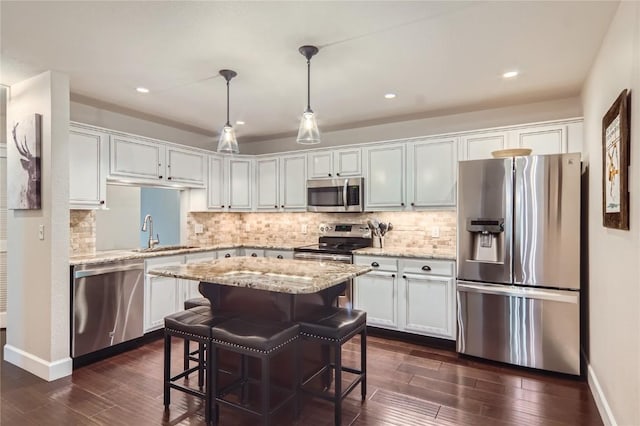 1437 Morgan Ct Unit 1437, Steamboat Springs, CO 80487 - kitchen with stainless steel appliances, a center island, dark wood-style floors, backsplash, and recessed lighting