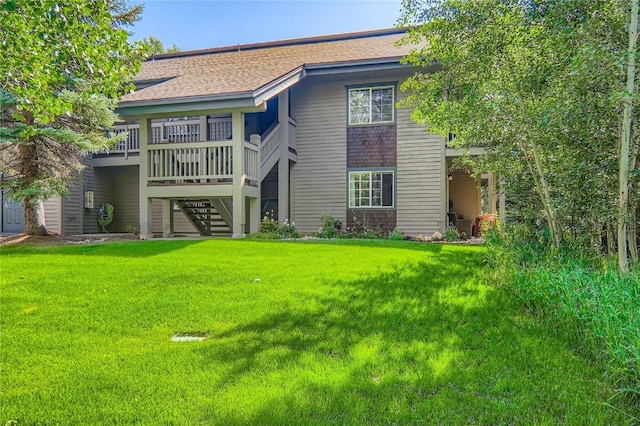 1437 Morgan Ct Unit 1437, Steamboat Springs, CO 80487 - rear view of property with stairs, a yard, roof with shingles, and a wooden deck