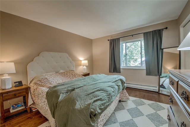 101 Blue Grouse Ln Unit D, Silverthorne, CO 80498 - bedroom with a baseboard radiator and dark wood-style floors