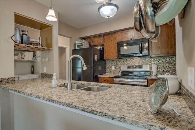 101 Blue Grouse Ln Unit D, Silverthorne, CO 80498 - kitchen featuring stainless steel electric range oven, black microwave, freestanding refrigerator, backsplash, and brown cabinets