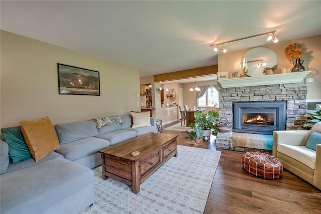 101 Blue Grouse Ln Unit D, Silverthorne, CO 80498 - living area featuring wood finished floors and a stone fireplace