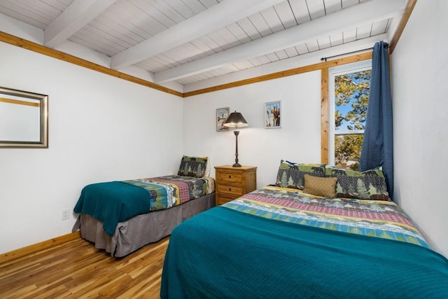 2200 Lodgepole Cir Unit 204, Silverthorne, CO 80498 - bedroom with beamed ceiling, baseboards, wood finished floors, and wood ceiling