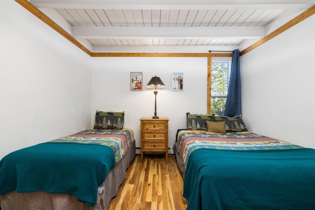 2200 Lodgepole Cir Unit 204, Silverthorne, CO 80498 - bedroom featuring beamed ceiling, wood finished floors, a baseboard radiator, and wood ceiling