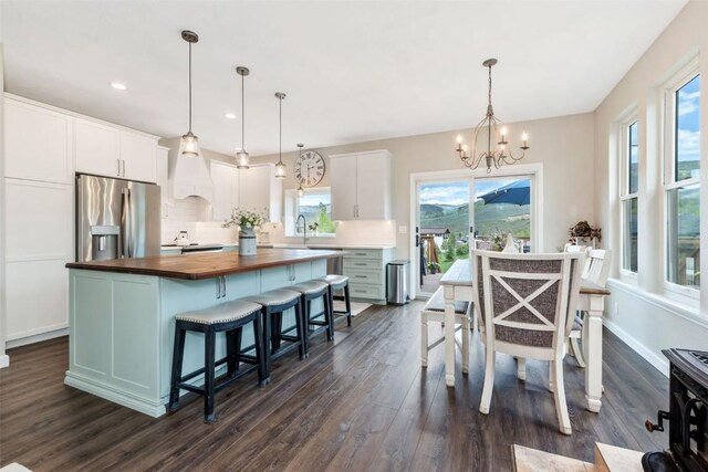 30600 Ormega Way, Oak Creek, CO 80467 - kitchen featuring butcher block counters, stainless steel appliances, a chandelier, dark wood-style flooring, and a kitchen island