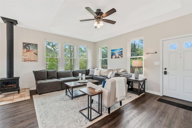 30600 Ormega Way, Oak Creek, CO 80467 - living room featuring a wood stove, dark wood finished floors, plenty of natural light, and a ceiling fan