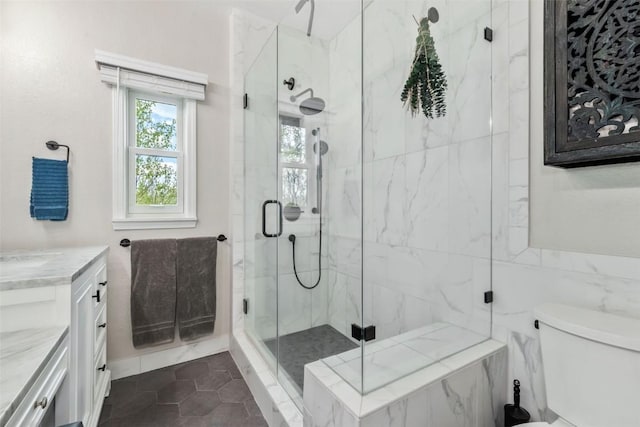 30600 Ormega Way, Oak Creek, CO 80467 - full bathroom with a marble finish shower, vanity, tile patterned floors, and toilet