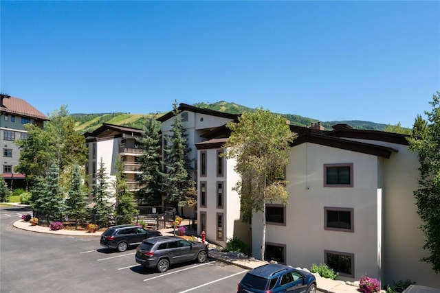 view of building exterior with uncovered parking