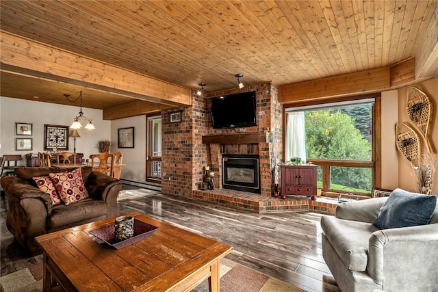 living area with an inviting chandelier, beamed ceiling, wood ceiling, a brick fireplace, and hardwood / wood-style flooring