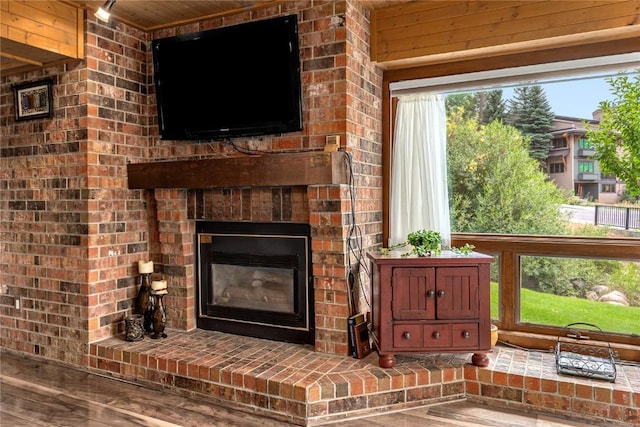 room details with wood finished floors and a brick fireplace