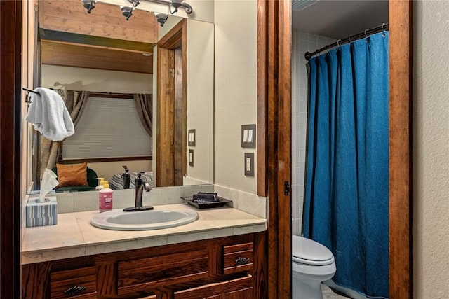 full bath with a shower with shower curtain, a textured wall, toilet, and vanity