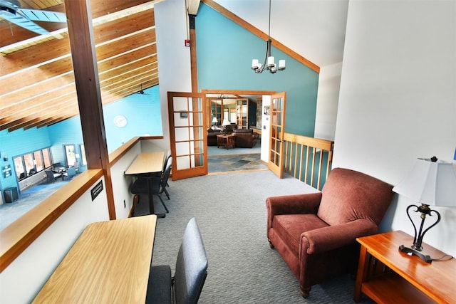sitting room featuring french doors, carpet flooring, beam ceiling, a notable chandelier, and high vaulted ceiling